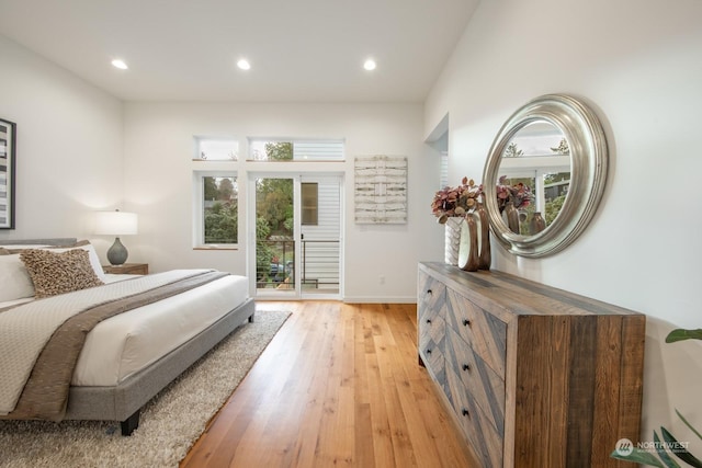 bedroom featuring light wood-type flooring and access to outside