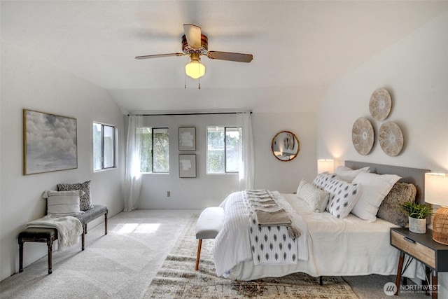 carpeted bedroom with lofted ceiling and a ceiling fan