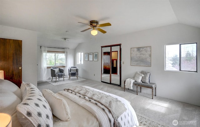 carpeted bedroom featuring vaulted ceiling, a closet, and ceiling fan