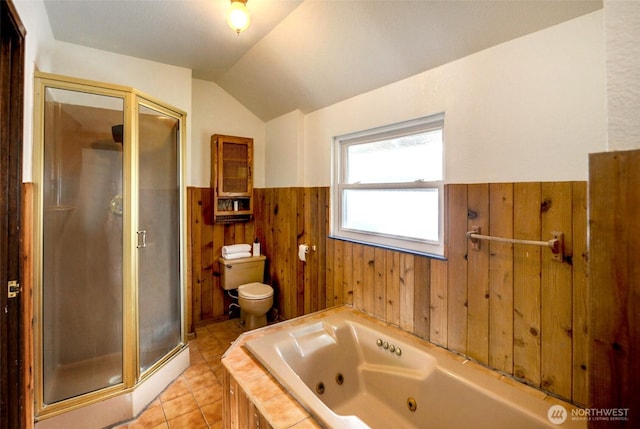 full bathroom featuring wood walls, toilet, a whirlpool tub, vaulted ceiling, and wainscoting