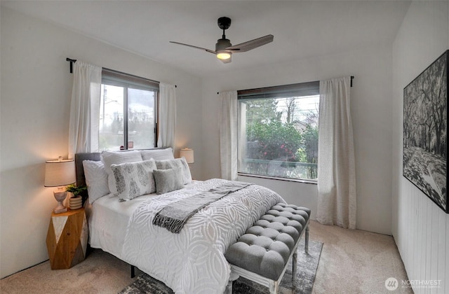 bedroom with a ceiling fan and light carpet