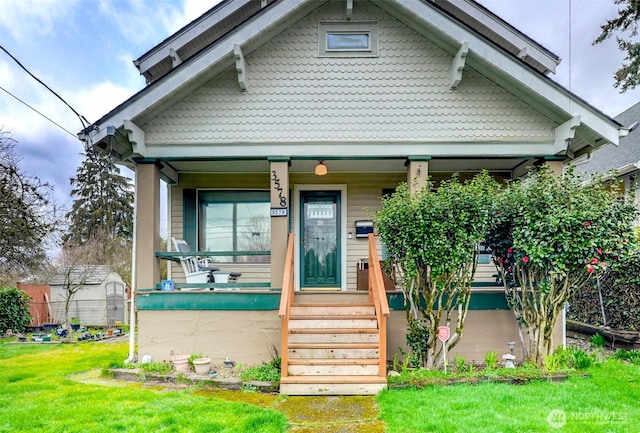 view of front of property with a front yard and covered porch