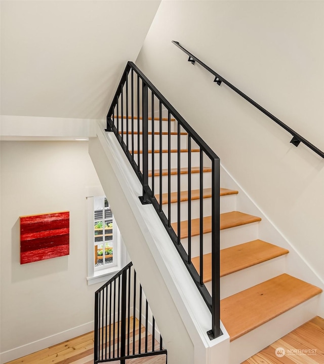 stairs with hardwood / wood-style flooring