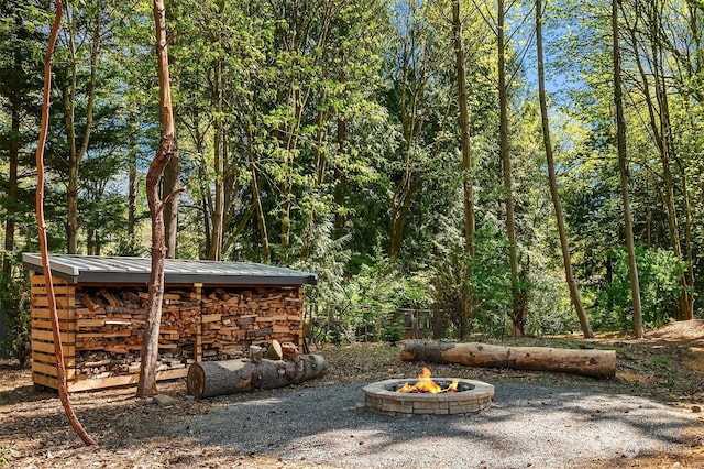 view of yard with a fire pit