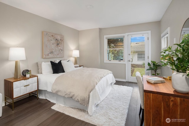 bedroom featuring access to outside and dark hardwood / wood-style flooring