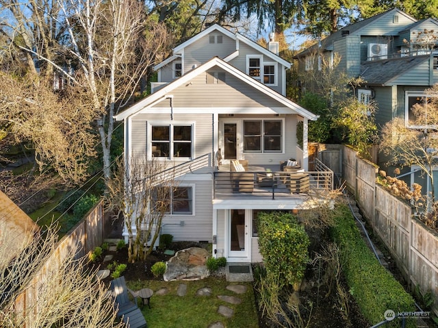 back of property with a balcony