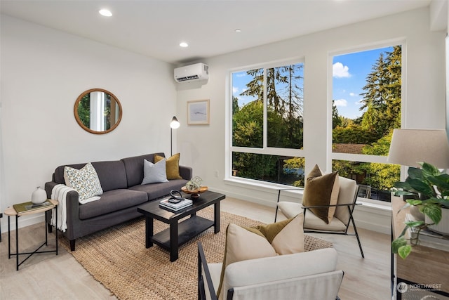 living room featuring a wealth of natural light, a wall mounted air conditioner, and light hardwood / wood-style flooring