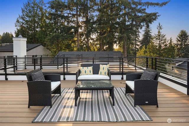 deck at dusk with an outdoor living space