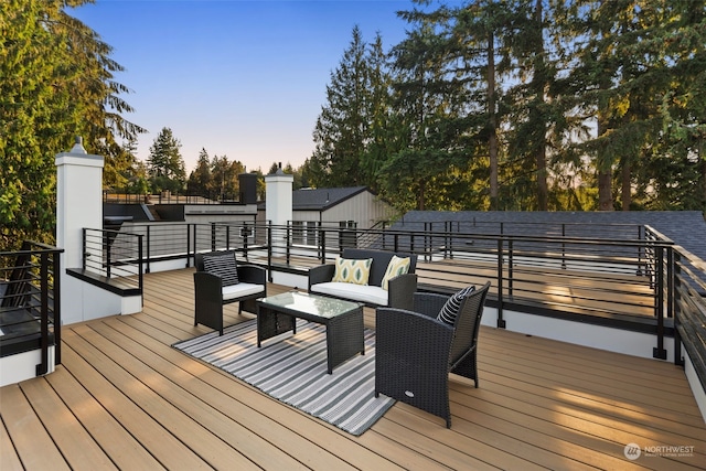 deck at dusk with outdoor lounge area