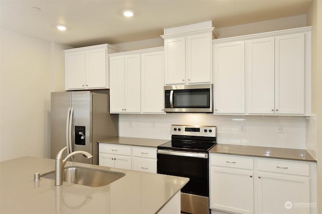 kitchen featuring stainless steel appliances, sink, and white cabinets