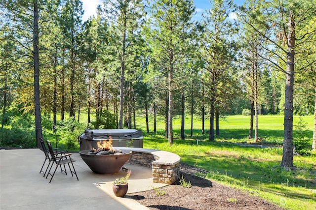 view of home's community featuring a yard, a patio, and an outdoor fire pit