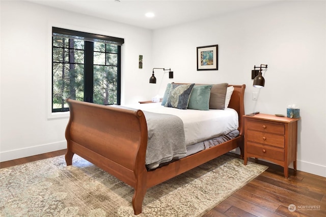 bedroom with dark wood-type flooring