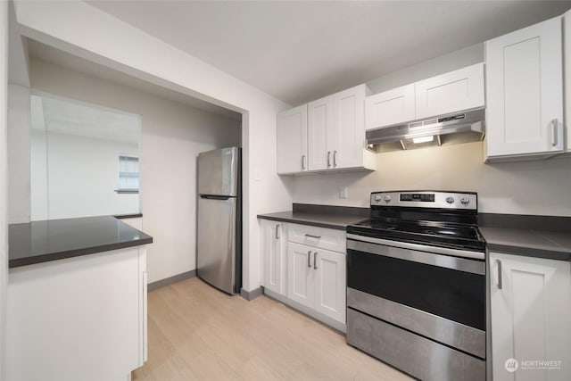 kitchen with white cabinetry, appliances with stainless steel finishes, and light hardwood / wood-style flooring