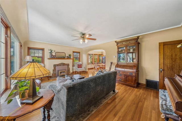 living room with ceiling fan and light wood-type flooring