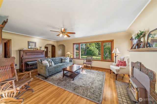 living room featuring hardwood / wood-style floors and ceiling fan