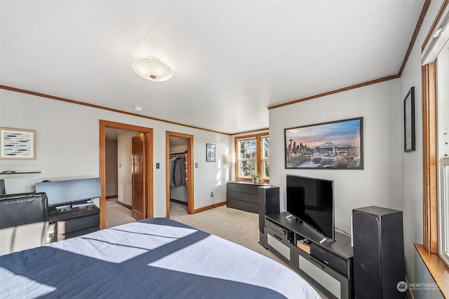 bedroom featuring crown molding, a walk in closet, light carpet, and a closet