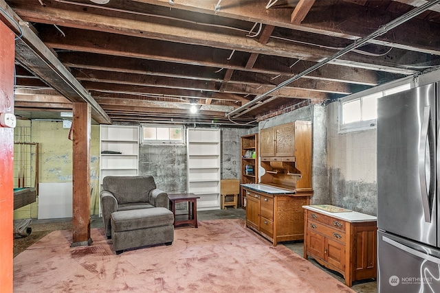 basement featuring stainless steel fridge