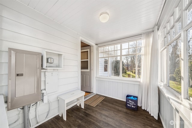 sunroom featuring wooden ceiling, electric panel, and a wealth of natural light