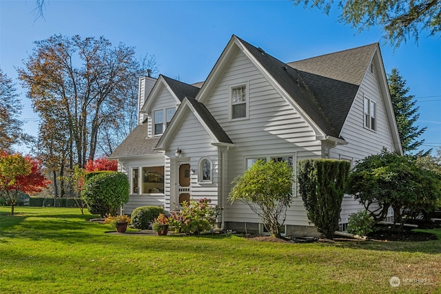 rear view of house with a yard