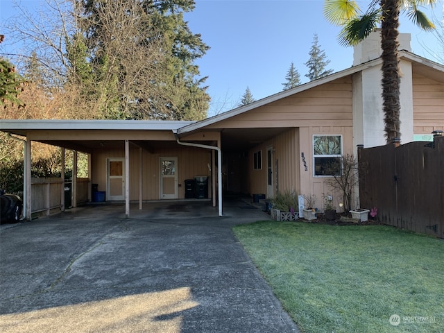 view of front of home with a front lawn and a carport