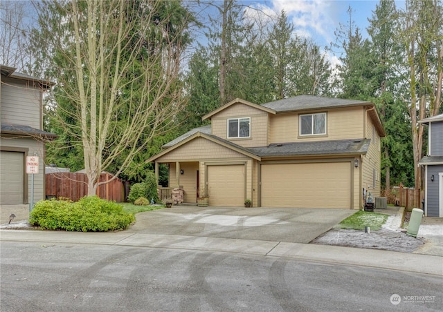 view of front of house featuring a garage and central AC