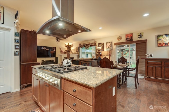 kitchen with stainless steel gas stovetop, a center island, island range hood, and dark hardwood / wood-style floors