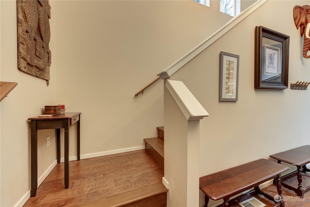 stairs featuring wood-type flooring