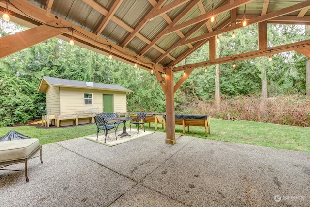 view of patio / terrace with an outbuilding and a gazebo