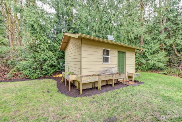 view of outbuilding featuring a yard