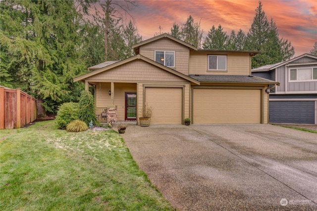 view of front facade featuring a garage and a yard