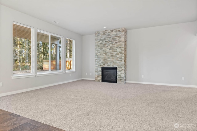 unfurnished living room featuring carpet flooring and a fireplace