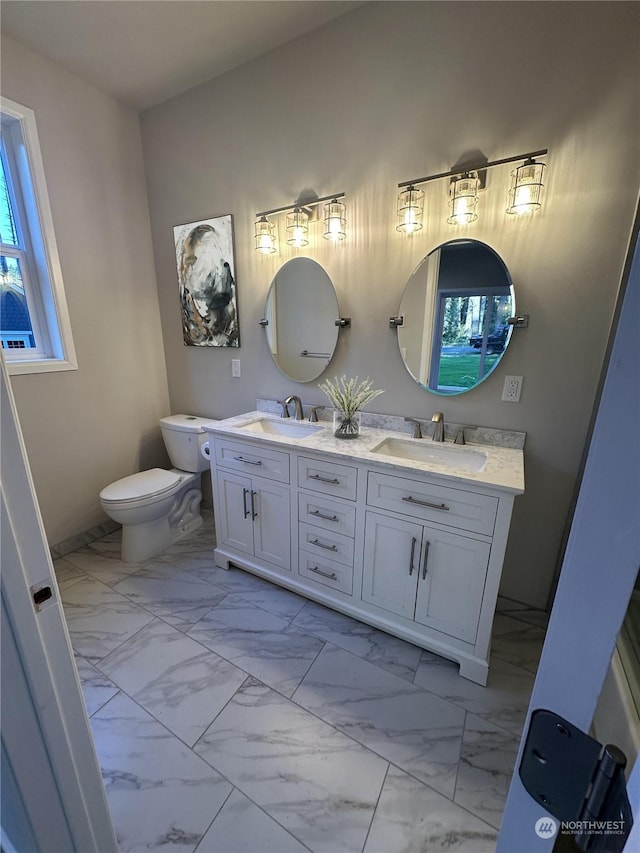 bathroom featuring vanity and toilet