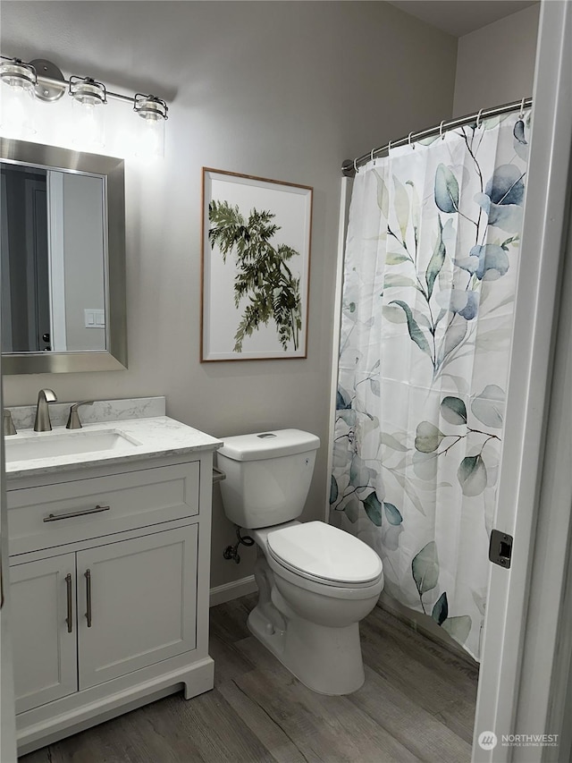 bathroom with hardwood / wood-style flooring, vanity, toilet, and a shower with shower curtain