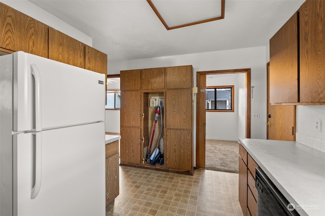 kitchen with dishwasher, white fridge, and a wealth of natural light