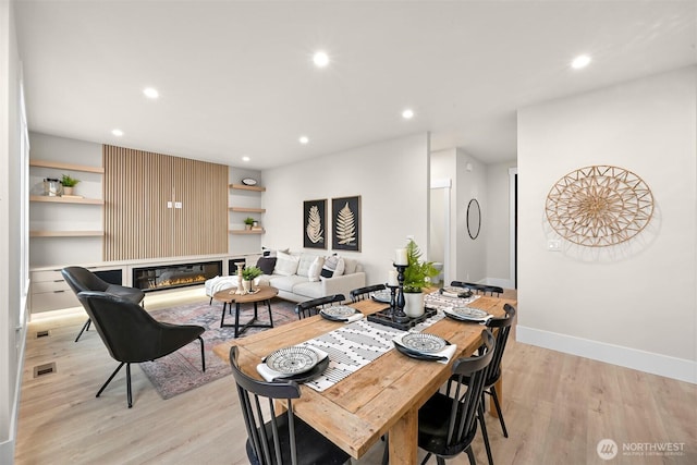 dining room featuring light wood-type flooring, visible vents, baseboards, and recessed lighting