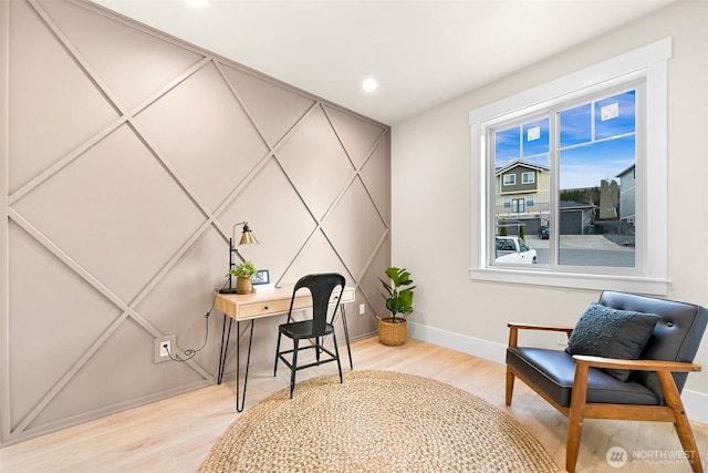 office space featuring light wood finished floors, recessed lighting, and baseboards