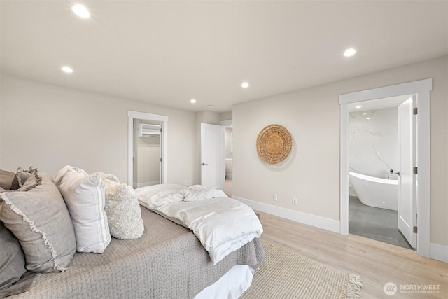 bedroom with light wood-type flooring, baseboards, and recessed lighting