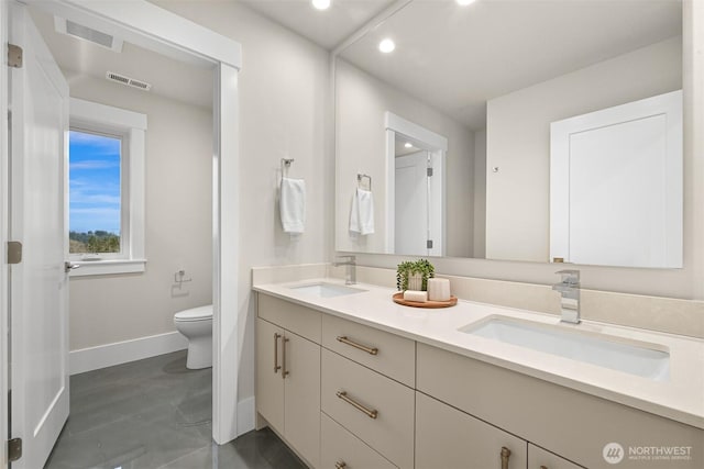 bathroom with double vanity, visible vents, toilet, and a sink