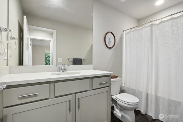 bathroom featuring vanity and toilet