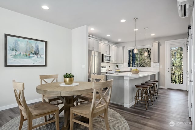 dining space with dark hardwood / wood-style floors