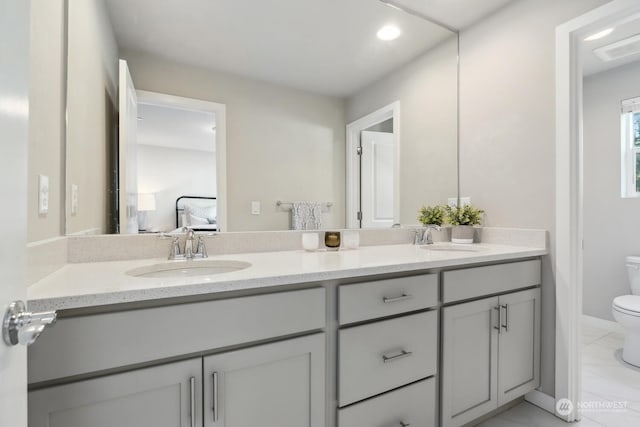 bathroom featuring vanity and toilet