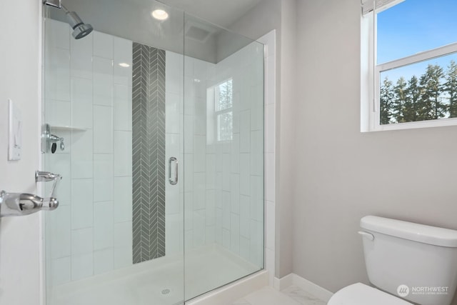 bathroom featuring an enclosed shower and toilet