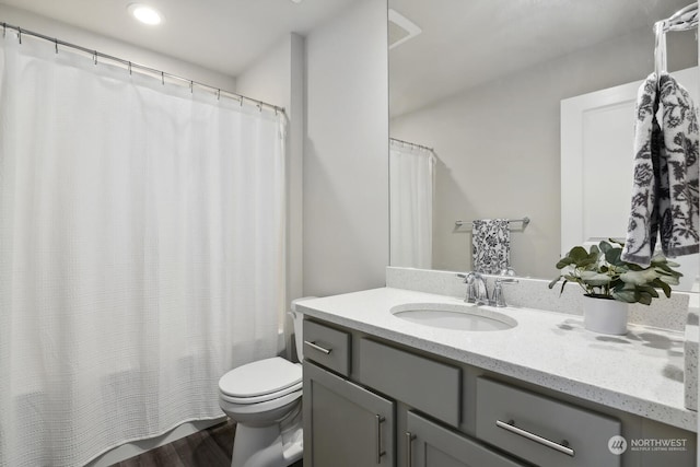 bathroom featuring vanity and toilet