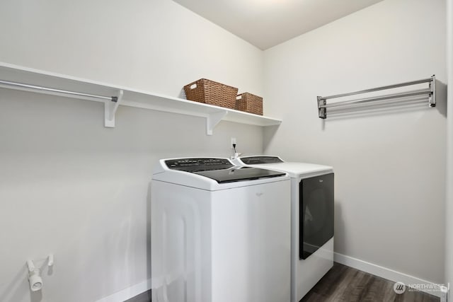 laundry room with dark hardwood / wood-style flooring and washing machine and dryer