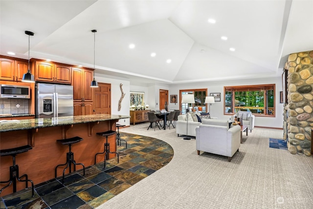 living room with high vaulted ceiling and dark colored carpet