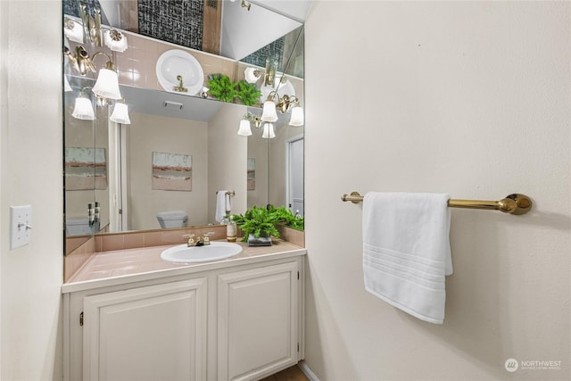 bathroom featuring vanity and toilet