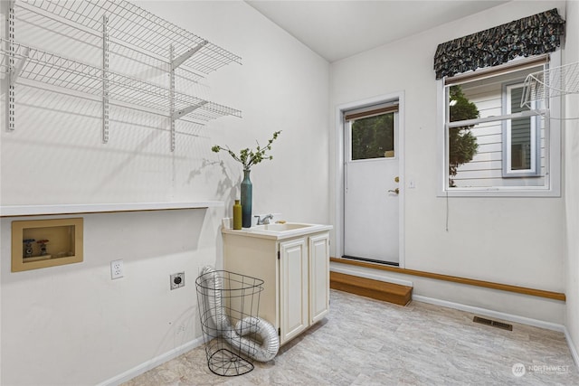 laundry area featuring cabinets, sink, hookup for an electric dryer, and hookup for a washing machine