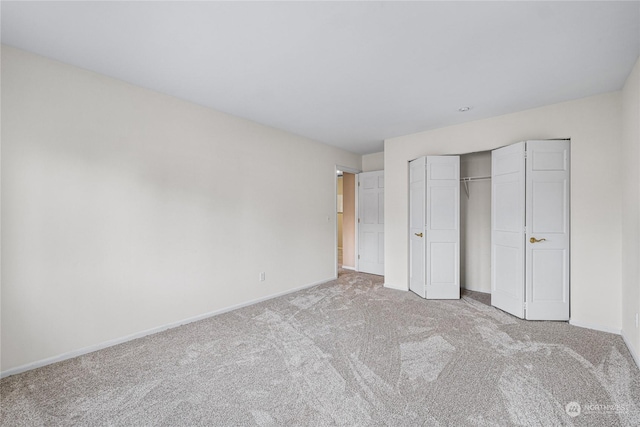 unfurnished bedroom featuring a closet and light carpet