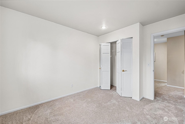 unfurnished bedroom with light colored carpet