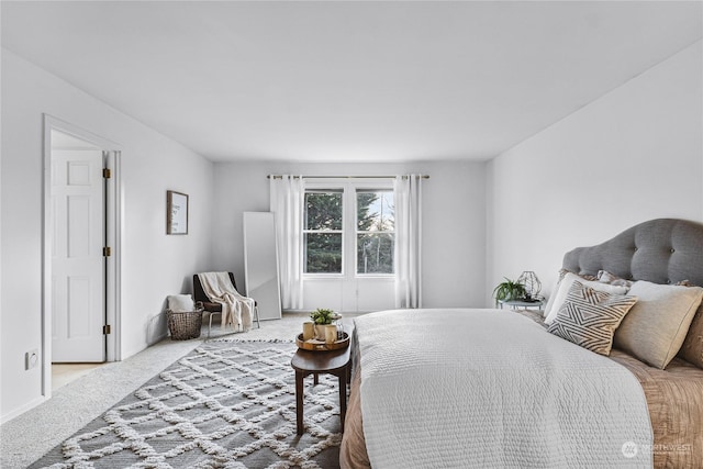 bedroom featuring light colored carpet